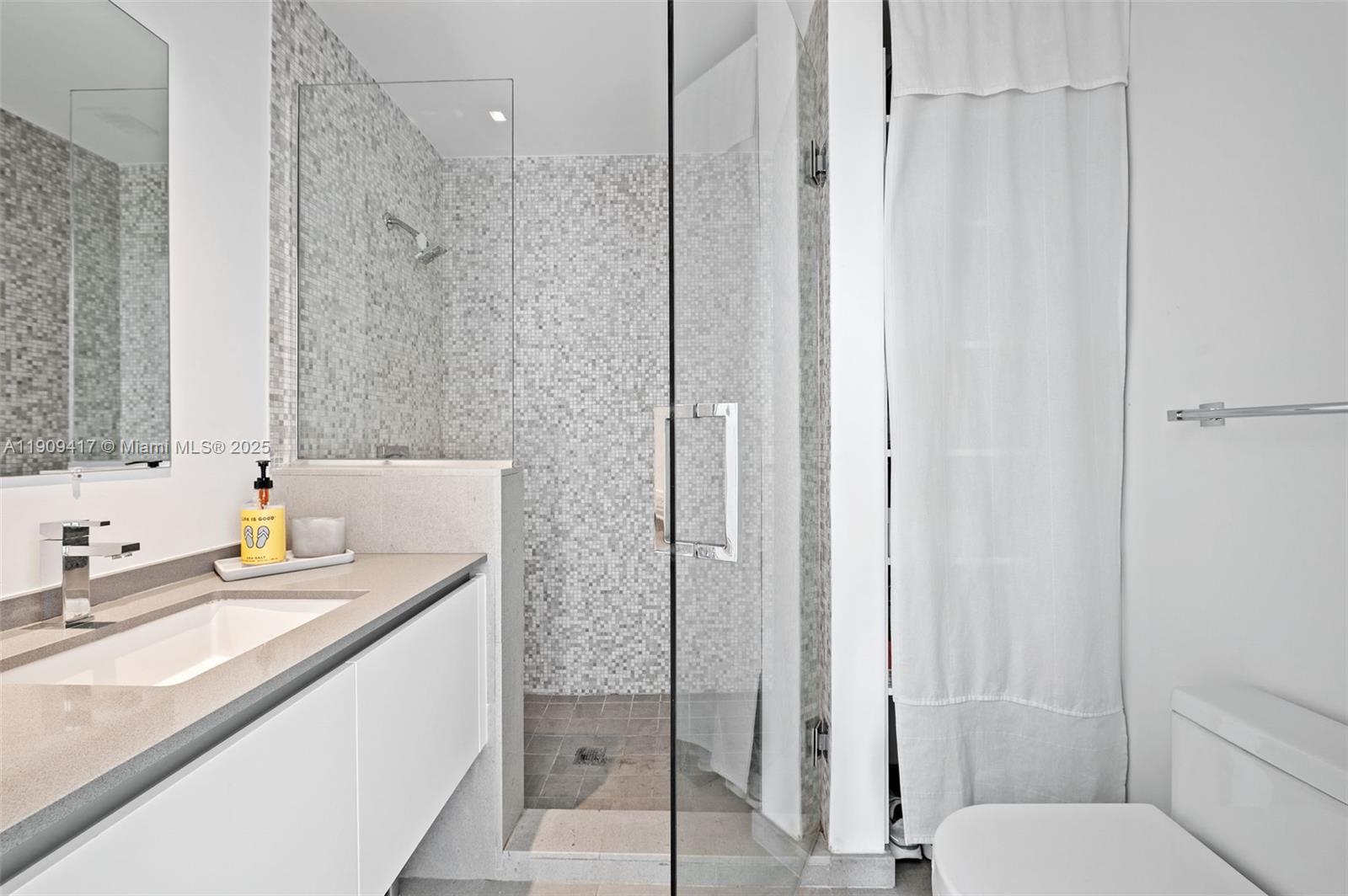 88 Southwest 7th Street, Unit 3101 Miami, FL 33130 - Photo 21 of 35 a bathroom with a granite countertop sink toilet and shower