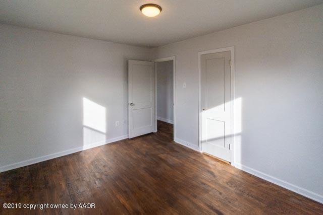 4435 Bowie Street Amarillo, TX 79110 - Photo 3 of 17 an empty room with wooden floor and windows