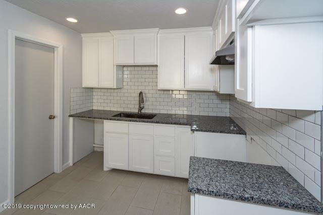 4435 Bowie Street Amarillo, TX 79110 - Photo 8 of 17 a kitchen with stainless steel appliances granite countertop a sink stove and cabinets