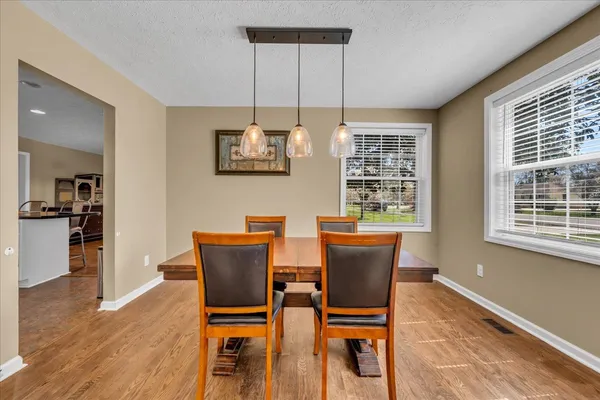 a view of a dining room with furniture window and wooden floor