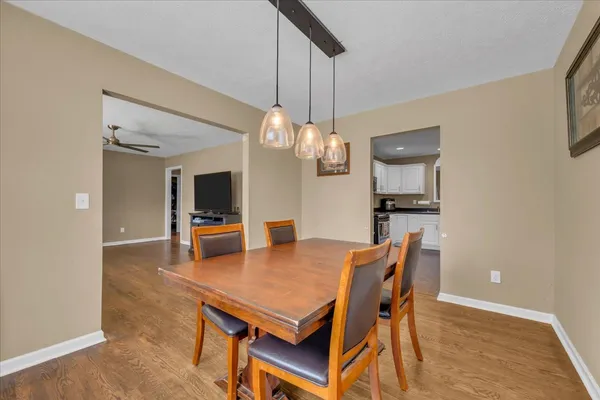 a view of a dining room with furniture and wooden floor