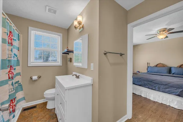 a bathroom with a sink a toilet and a large mirror