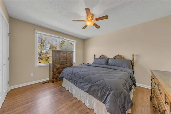 a bed sitting in a bedroom next to a window