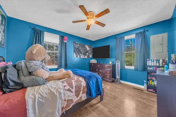 a bedroom with natural light and a bed