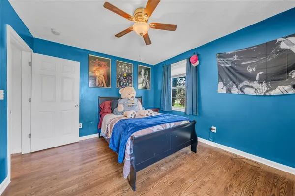 a bedroom with a bed and a chandelier