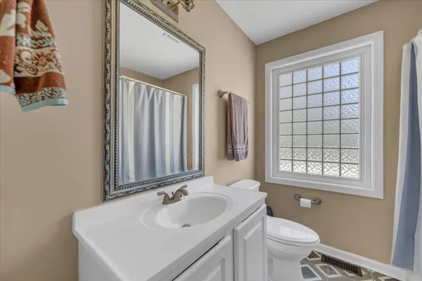 a bathroom with a sink toilet and mirror
