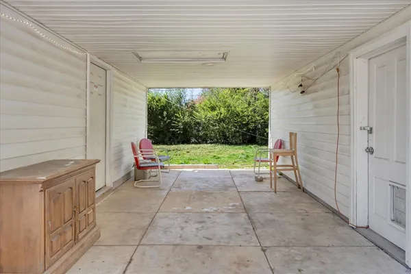 a view of a house with backyard porch and sitting area