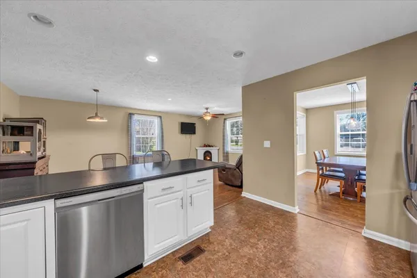 a kitchen with granite countertop a sink and cabinets