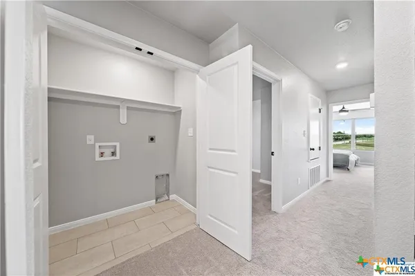 a view of a hallway with closet and a bathroom