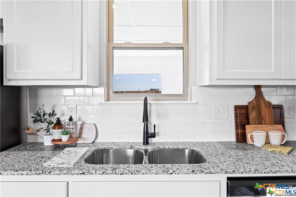 746 Meiomi Drive Temple, TX 76502 - Photo 6 of 32 a kitchen with granite countertop a sink and a stove