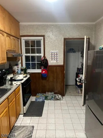 a kitchen with a sink a stove and refrigerator
