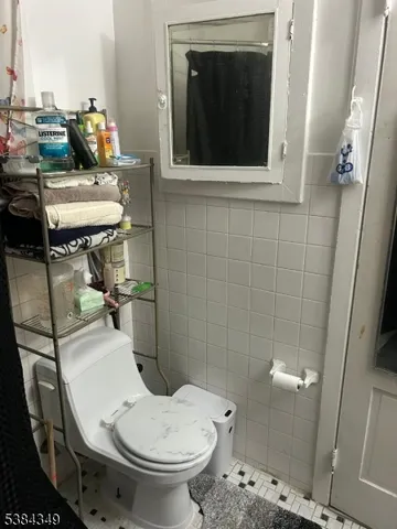 a bathroom with a toilet a sink and a mirror