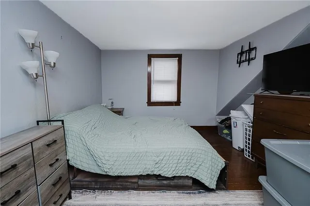 a bedroom with a bed and flat screen tv
