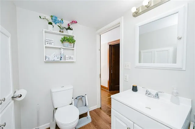 a bathroom with a sink mirror vanity and toilet