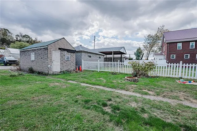 a view of a house with yard and a garden