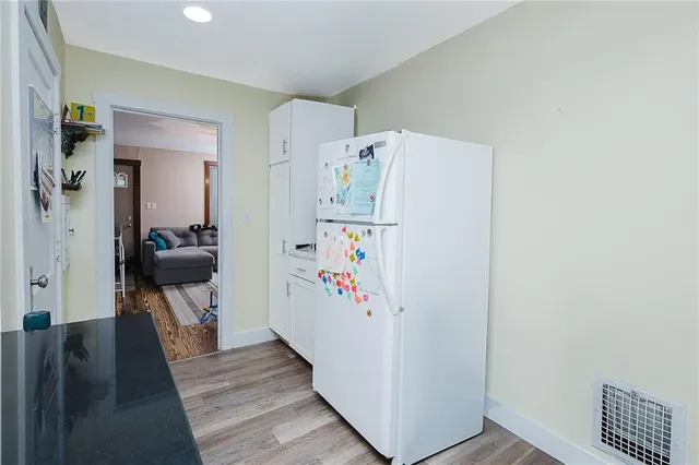 a white refrigerator freezer sitting inside of a kitchen