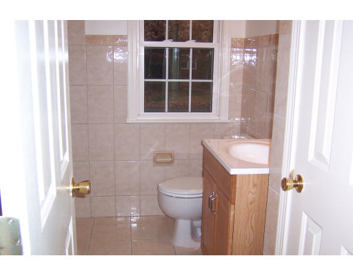 48 Donna Road Bellingham, MA 02019 - Photo 3 of 6 a bathroom with a toilet a sink and shower