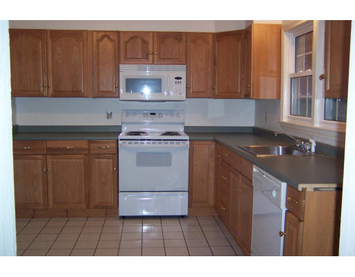 48 Donna Road Bellingham, MA 02019 - Photo 4 of 6 a kitchen with a stove and a microwave