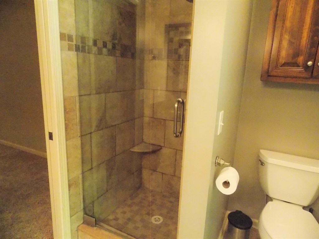 562 Evergreen Drive Fortson, GA 31808 - Photo 11 of 17 a bathroom with a shower and a toilet