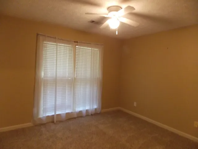 an empty room with a empty space and a ceiling fan