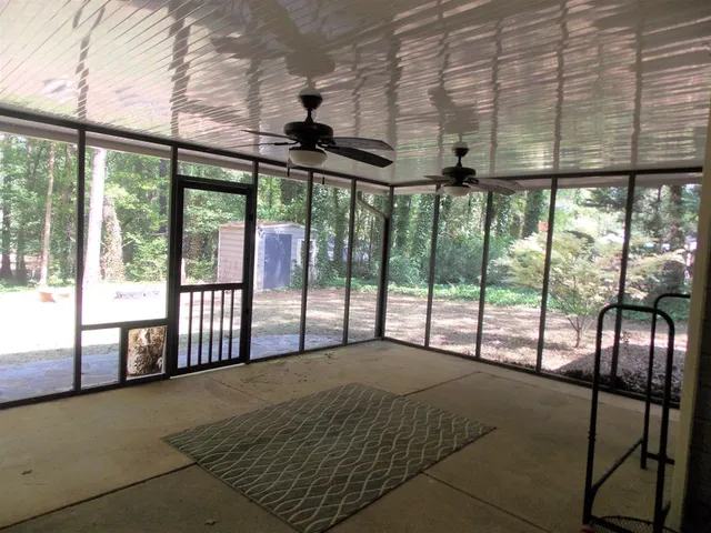 a bedroom with a large bed and a large window