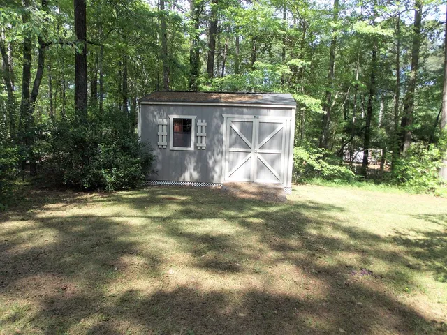 a view of house with backyard and garden