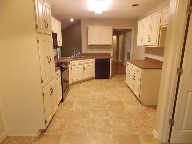 a kitchen with stainless steel appliances a refrigerator sink and cabinets