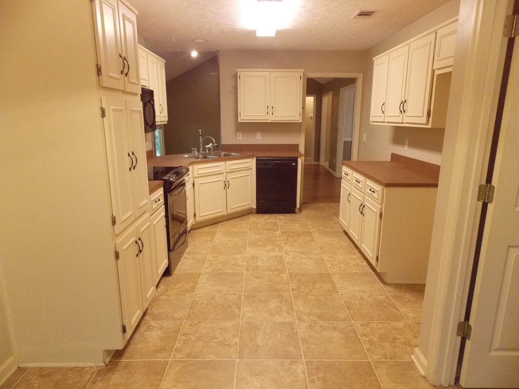 562 Evergreen Drive Fortson, GA 31808 - Photo 7 of 17 a kitchen with stainless steel appliances a refrigerator sink and cabinets