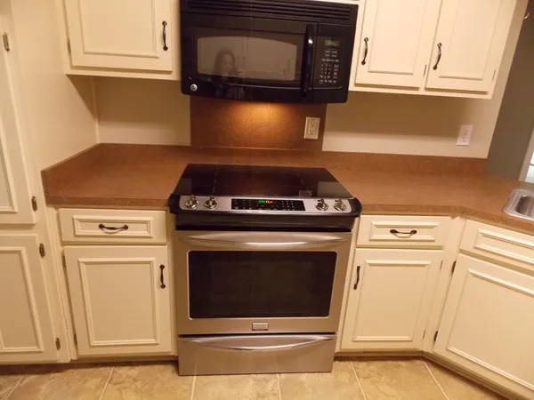 a stove top oven sitting inside of a kitchen