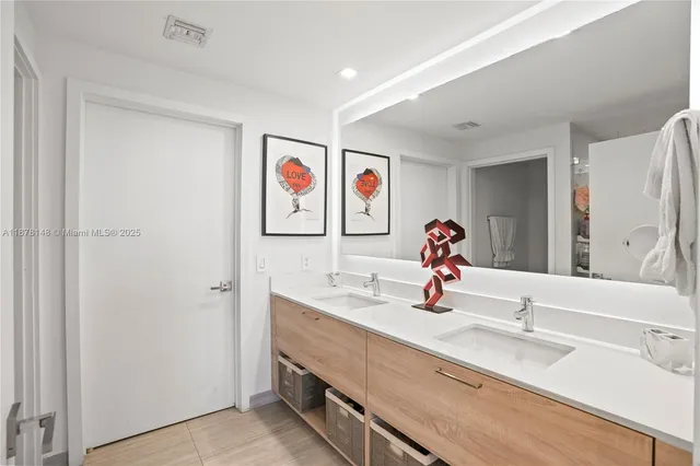 a bathroom with a sink double vanity and mirror