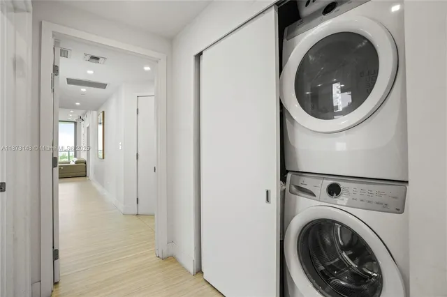 a view of a hallway with washer and dryer