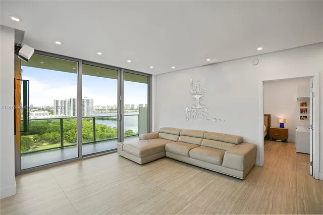 a living room with furniture and large windows