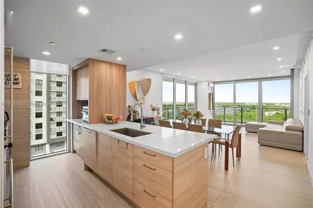 a kitchen with a large window and white cabinets