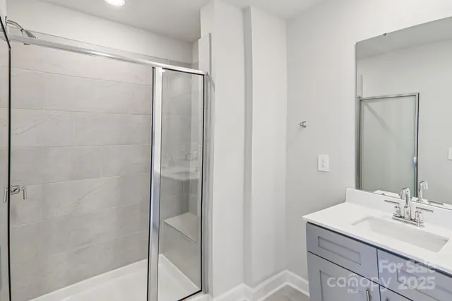 a bathroom with a shower and a sink