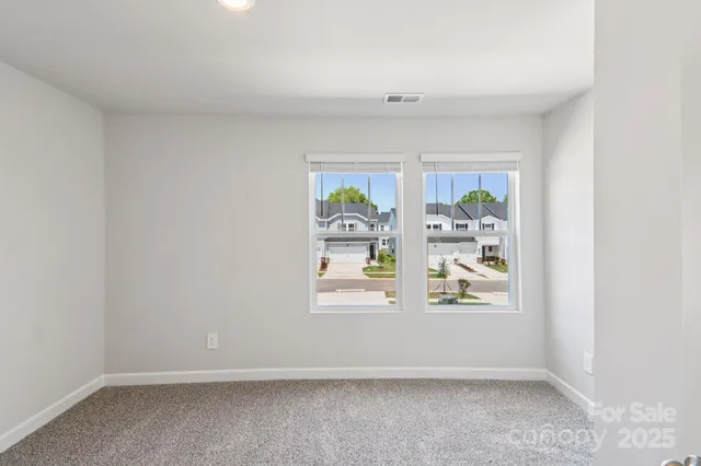 an empty room with windows and window