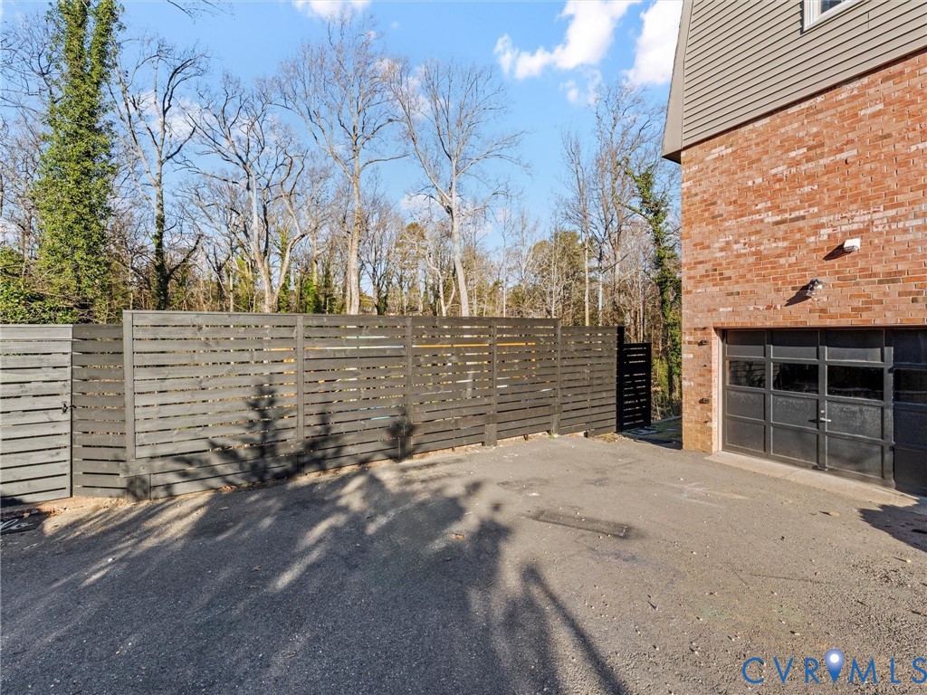 8636 Trabue Road Richmond, VA 23235 - Photo 44 of 50 Side Entry Garage metal gate with entry to the yar