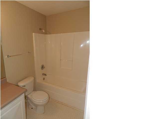 504 Keystone Road, Unit 504 Mary Esther, FL 32569 - Photo 11 of 20 a white toilet sitting next to a bathroom sink