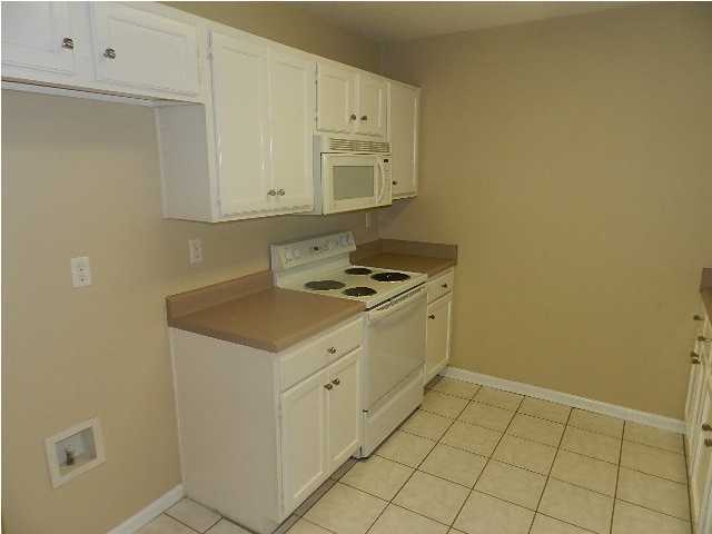 504 Keystone Road, Unit 504 Mary Esther, FL 32569 - Photo 6 of 20 a kitchen with granite countertop white cabinets and white appliances