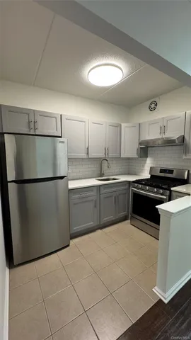 a kitchen with stainless steel appliances granite countertop a refrigerator sink and cabinets