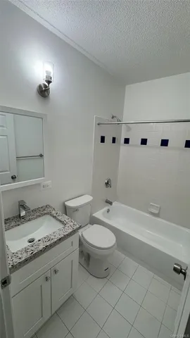 a bathroom with a granite countertop sink a toilet and bathtub