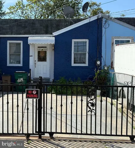 a view of a house with wooden fence