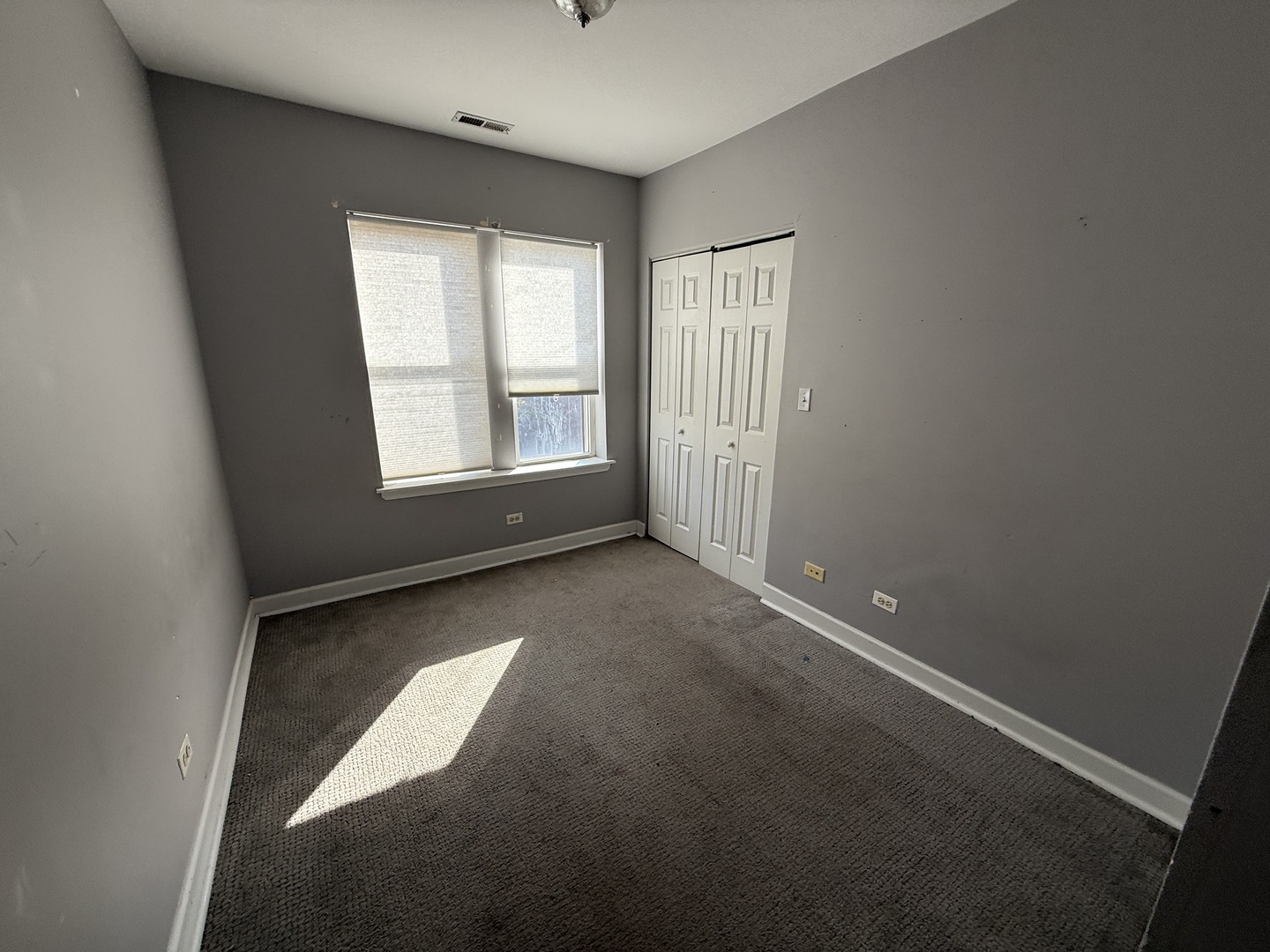2704 West Arthur Avenue, Unit 3S Chicago, IL 60645 - Photo 6 of 11 an empty room with windows
