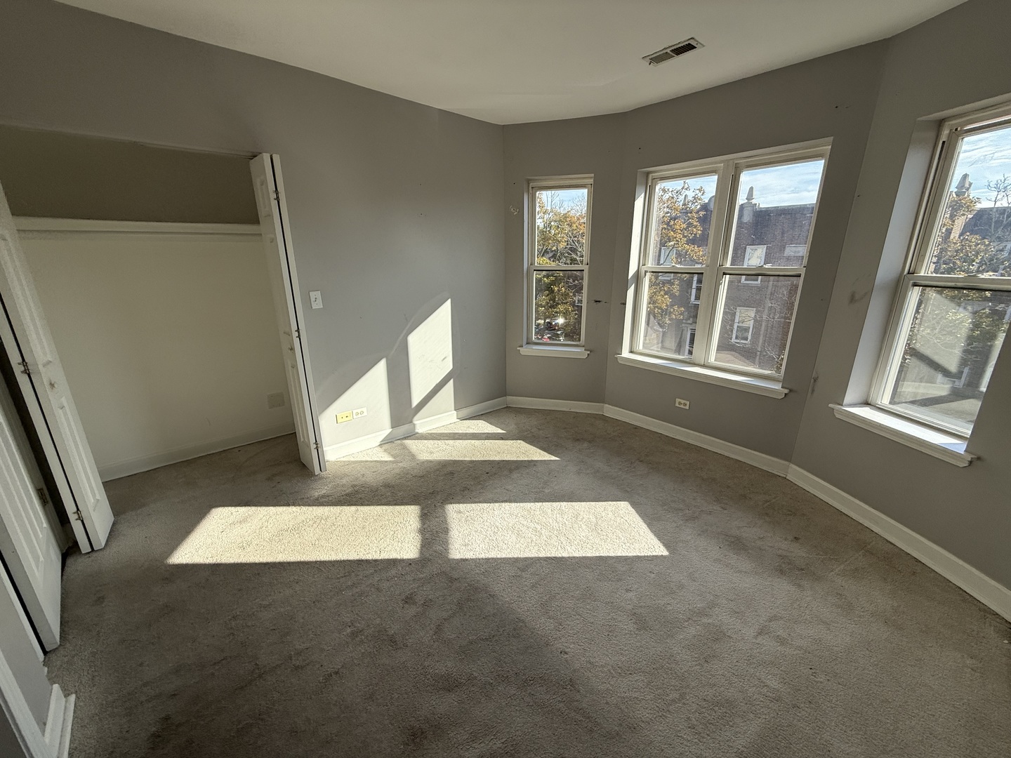 2704 West Arthur Avenue, Unit 3S Chicago, IL 60645 - Photo 8 of 11 an empty room with windows