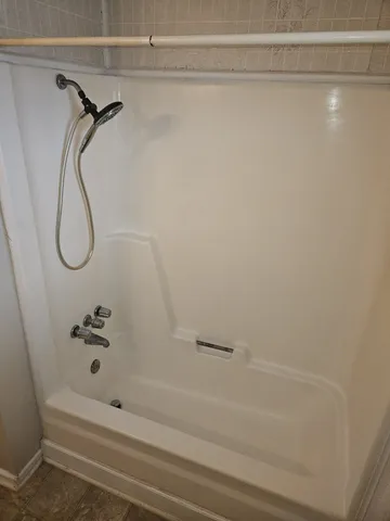 a bathroom with a shower and a shower