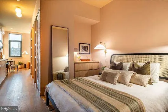 a bedroom with a bed and a chandelier