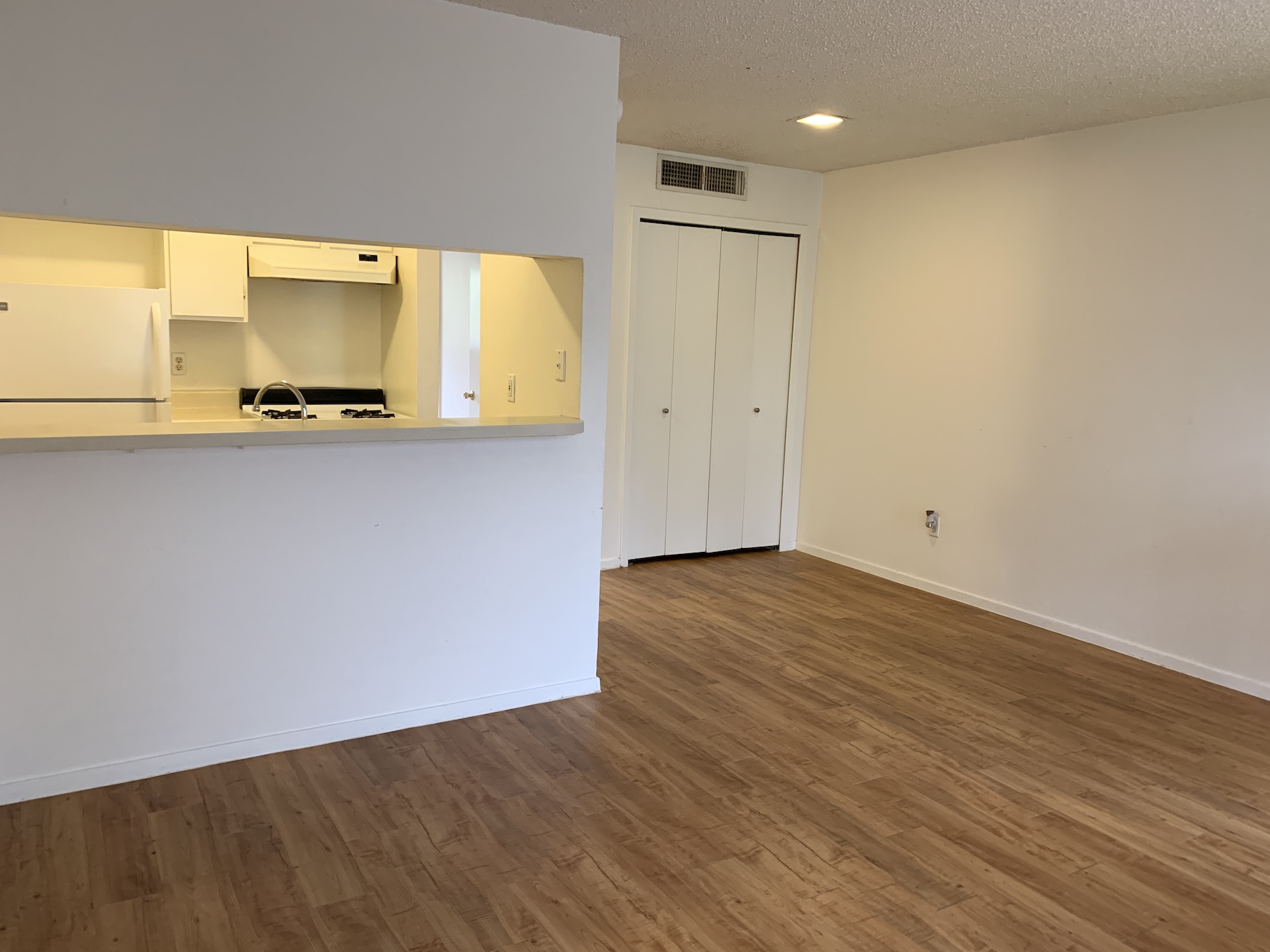 10810 Newmont Road, Unit 3 Austin, TX 78758 - Photo 2 of 8 Kitchen with freestanding refrigerator, light countertops, a textured ceiling, dark wood-style flooring, and gas stove