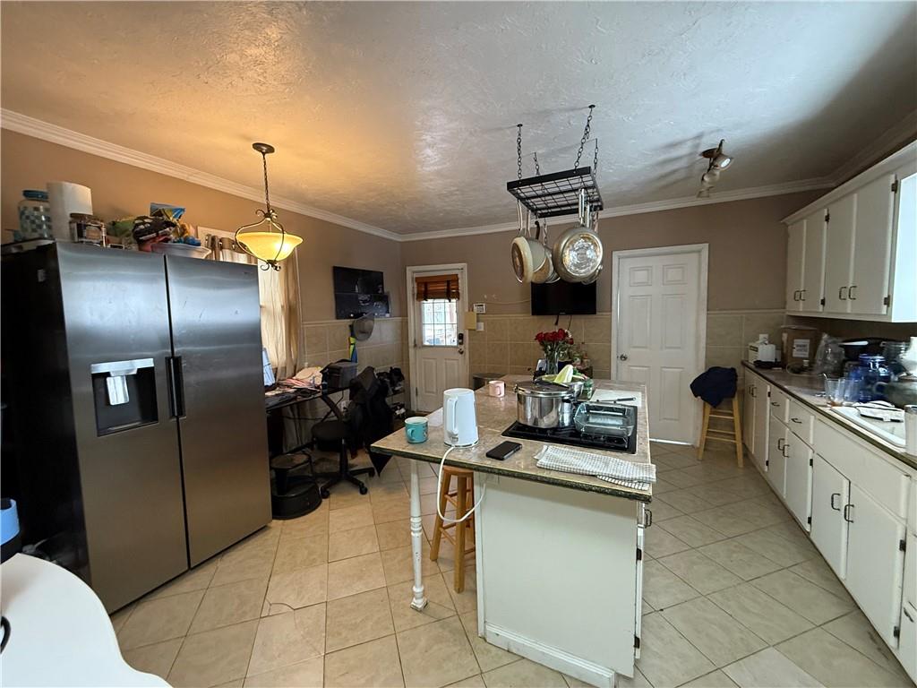 4111 Wildcat Road New Kensington, PA 15068 - Photo 7 of 21 a kitchen with refrigerator and cabinets