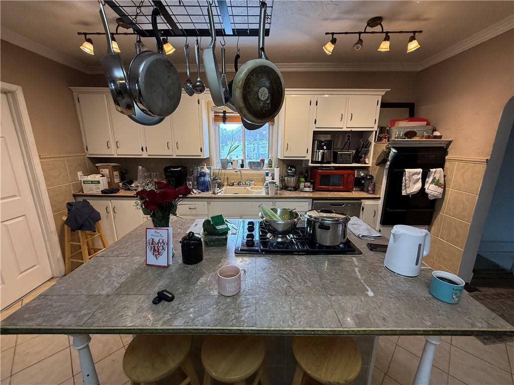 4111 Wildcat Road New Kensington, PA 15068 - Photo 10 of 21 a kitchen with a stove and a wooden floor