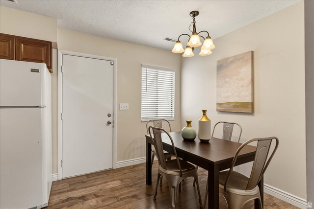 947 Canyon Road, Unit 29 Ogden, UT 84404 - Photo 9 of 19 Dining area featuring suspended lighting and wood finished floors