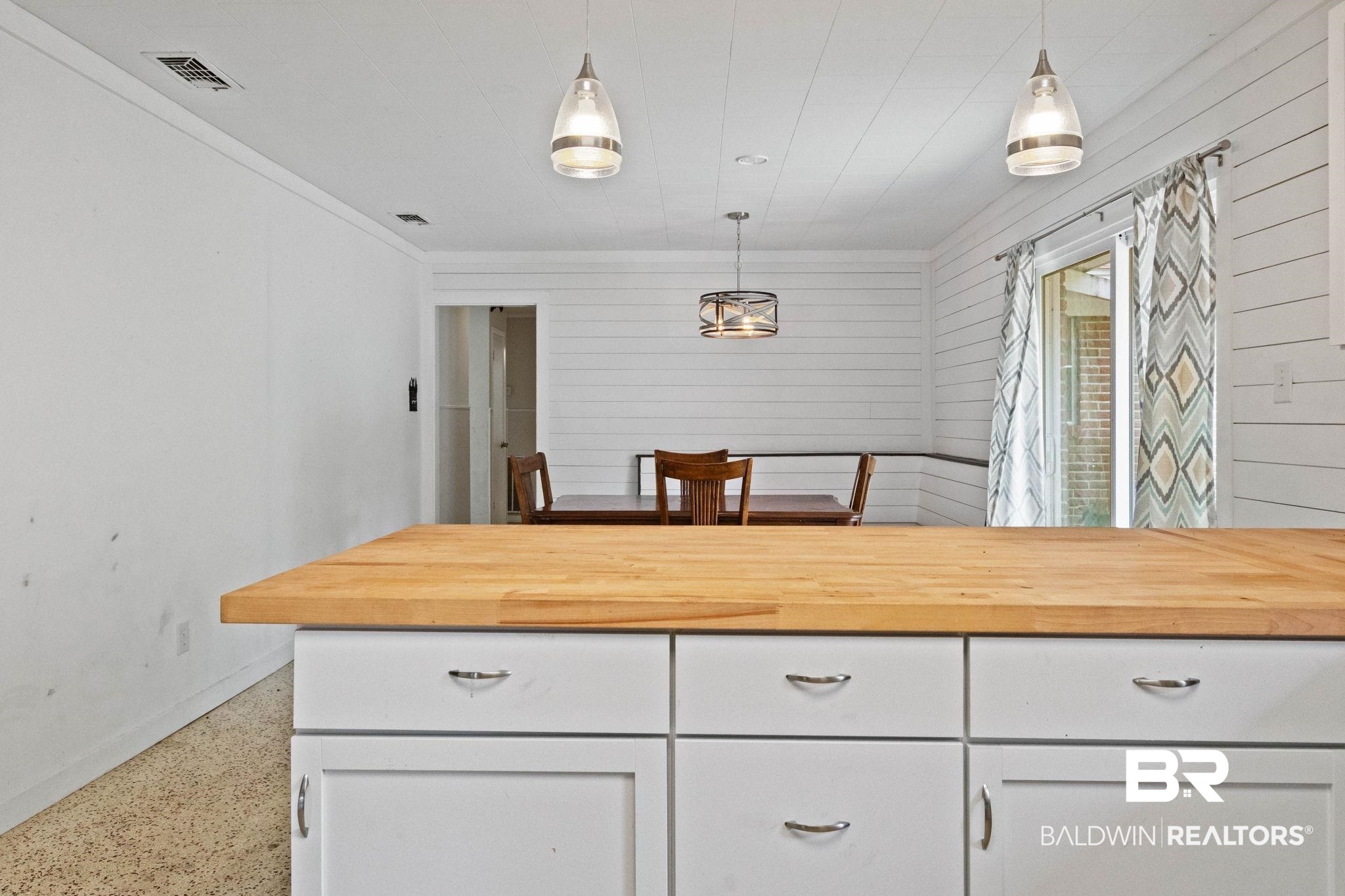 384 Old Bratt Road Atmore, AL 36502 - Photo 22 of 64 Butcher block countertop with white cabinetry and chrome hardware